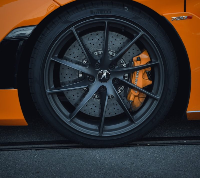 a close up of the front wheel of a sports car