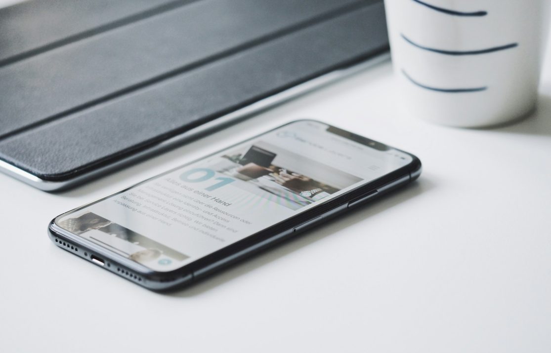 black smartphone beside black smart case