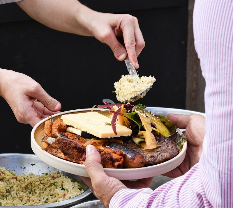 a person holding a plate of food